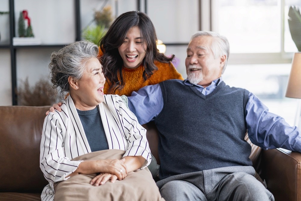A caregiver visiting with an older woman at home